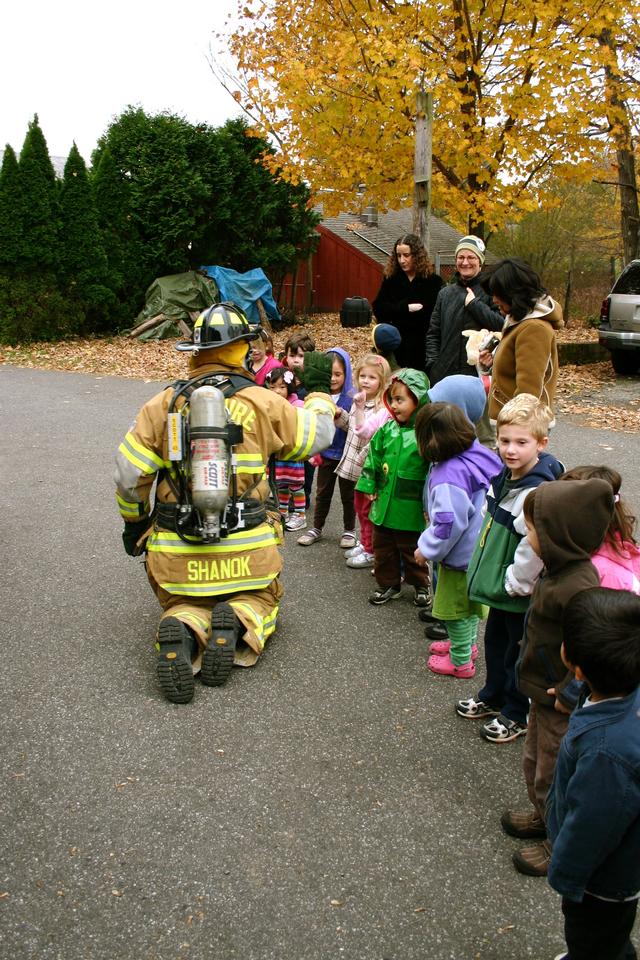 Veteran CFD Fire Fighter Jerry Shanok greets students at Boulder Knoll Montessori School.